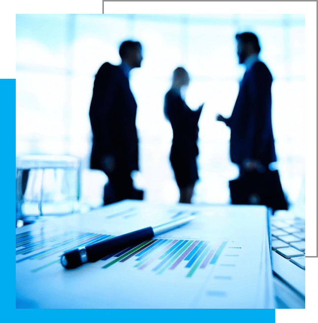 A group of people standing around a table.